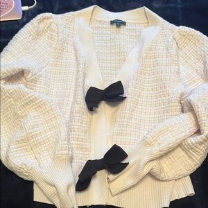 Elegant Cream Sweater with Black Bow Accents